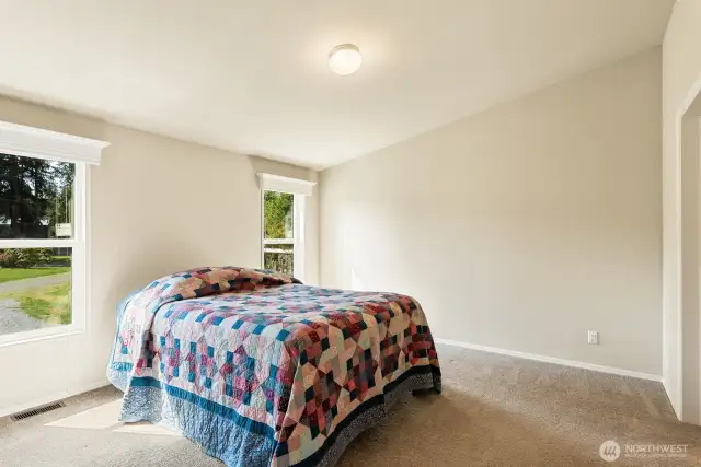 Primary Suite with 2 windows, walk in closet and full bath with dual vanity.