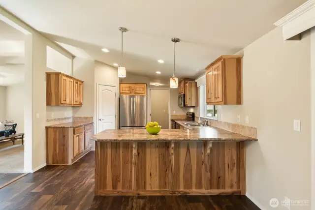 Eating bar in the kitchen, stainless appliances, & knotty pine cabinets.  Walk in pantry & lots of counter space!