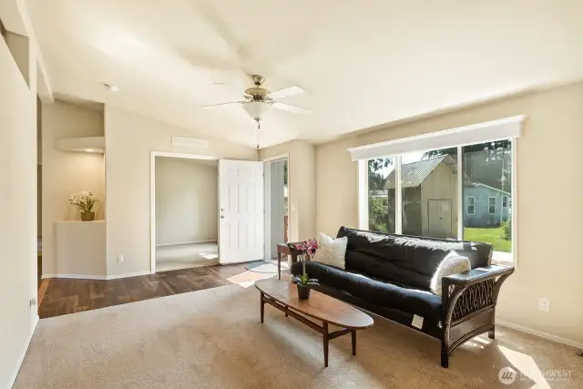 Formal living room with art niche, and french doors into the den.