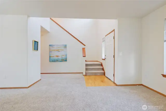 You’ll love coming home to the dramatic entry, featuring a freshly painted blue front door that makes a bold first impression. Inside, rich, wide-plank hardwood flooring offers both easy care and timeless beauty, setting the tone for a welcoming, elegant atmosphere. This inviting entryway creates a memorable first moment and sets the stage for comfortable living and effortless entertaining.