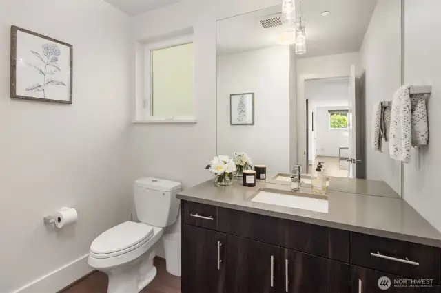 Bathroom near kitchen and living area.