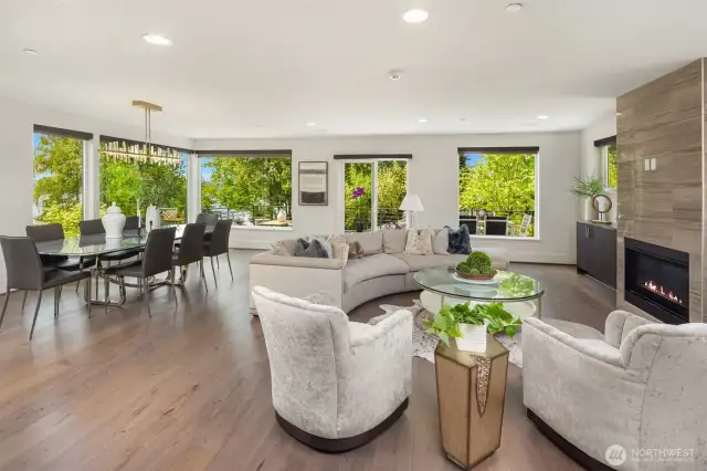 Light-filled open concept living on the main floor surrounded by windows with water, mountain and Seattle views.