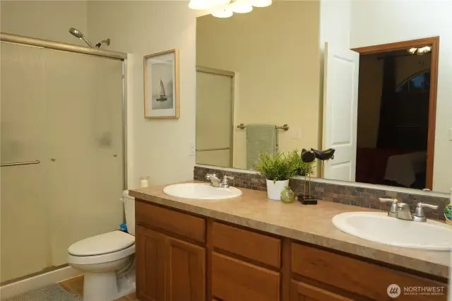 The primary bath has an oversize step in shower and double sinks.