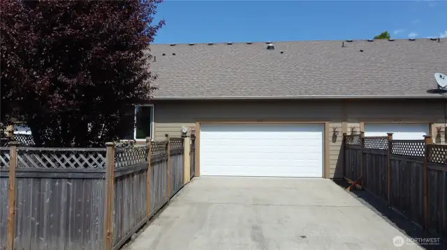 Double car garage with built in shelves, alley access and driveway parking.
