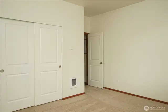 Second bedroom showing closet and entry door.