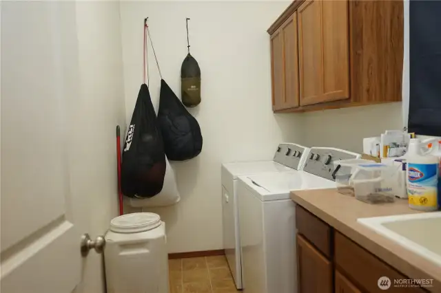 Laundry room with storage and a deep laundry sink.
