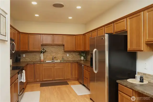 The U-shaped kitchen has tons of cabinets, stainless appliances and is wired for under cabinet lighting.