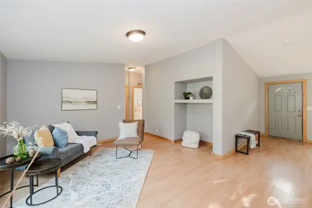 Welcoming living space with laminate floors and neutral tones.