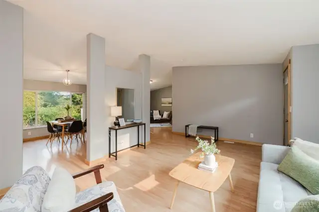 Open concept living room with seamless flow to dining area.