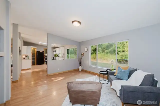 Light-filled living room with serene backyard views.