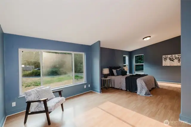 Primary bedroom with large window and peaceful views.