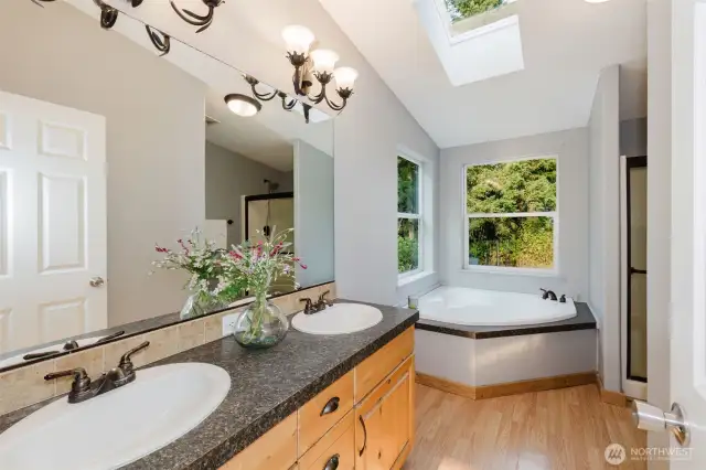 Primary bath with dual sinks and soaking tub.