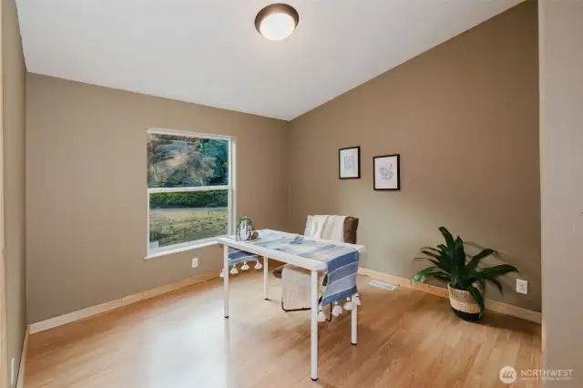 Secondary bedroom with neutral paint and laminate floors.