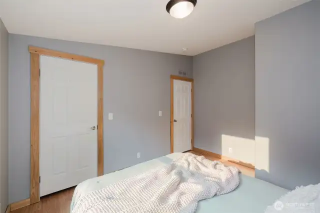Bedroom with closet and laminate floors.