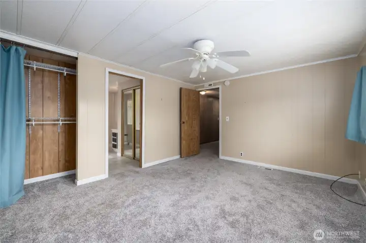 In this view of the primary bedroom, closet to the left, and note the additional closet just inside the bathroom door