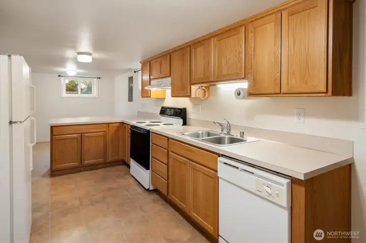 The lower level apartment kitchen opens to the dining room.