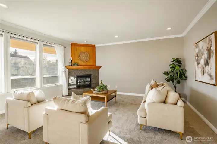 Living Room with new carpet, gas FP, 9' ceiling and lots of natural light