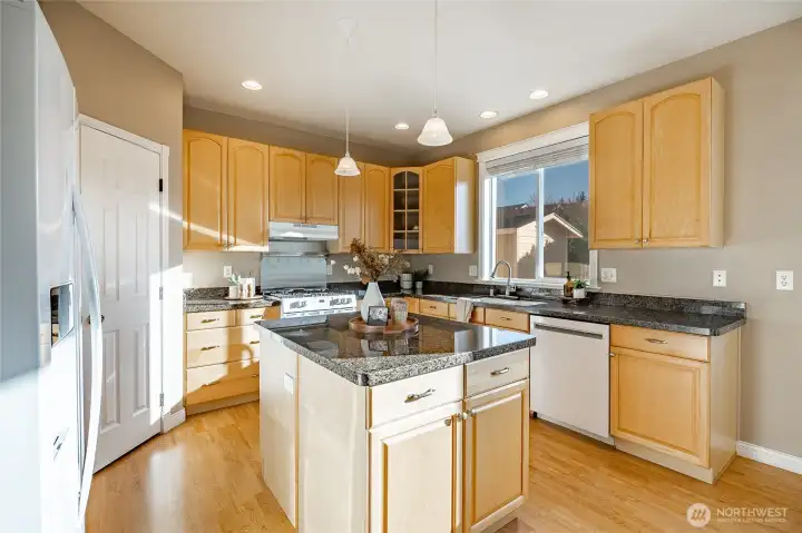 Kitchen with large island, granite countertops and walk-in pantry