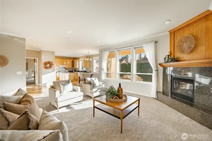 Living Room with new carpet, gas FP, 9' ceiling and lots of natural light
