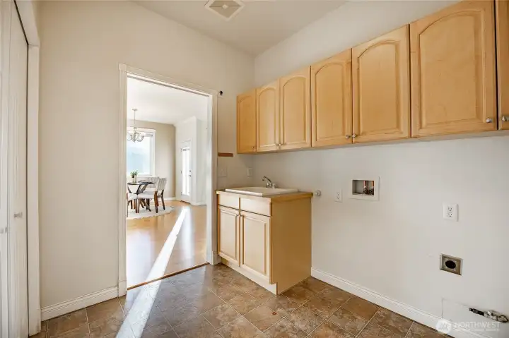 Spacious laundry room with wash sink and large closet