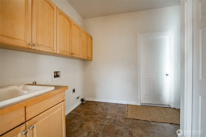 Spacious laundry room with wash sink and large closet
