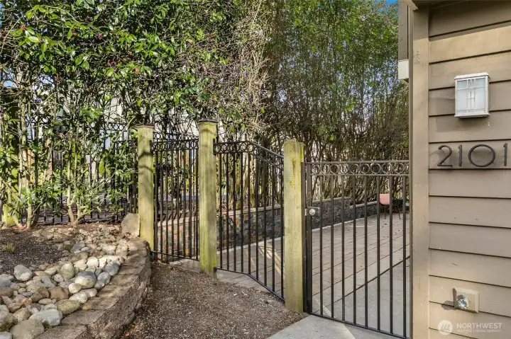 Gated entry leads to a private patio, providing privacy and simultaneously welcoming transition from the street to home.
