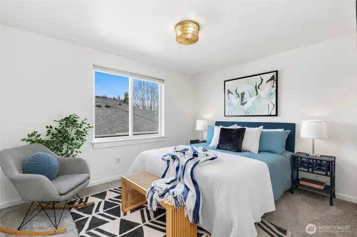 Bright upper-level second bedroom with eastern exposure, welcoming soft morning light and offering comfortable proportions for guests, kids, work-from-home flexibility, or roomate.