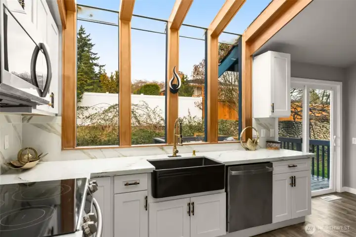 massive glass windows connecting to roof from kitchen countertops