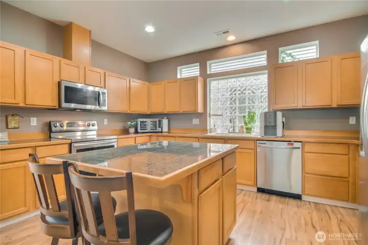 Natural light filled kitchen has large window