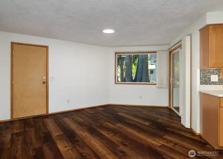 Dining room with door into the garage and slider into the sunroom