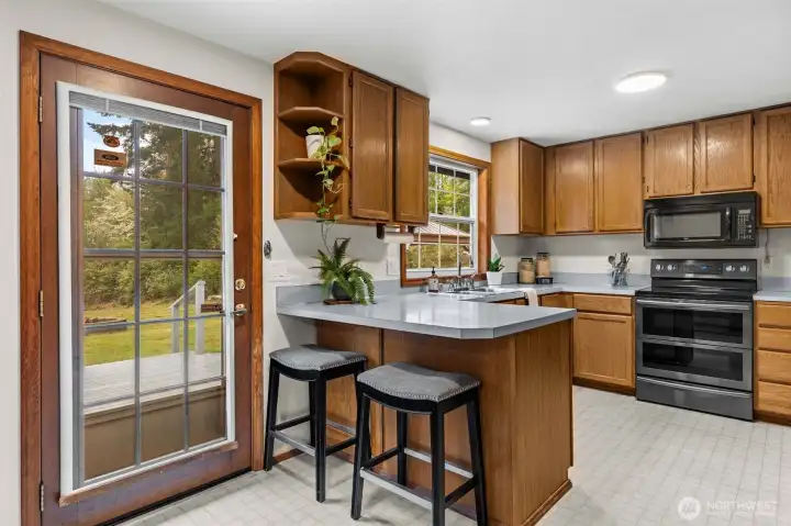 With ample cabinetry and a doorway opening to the expansive rear deck, this kitchen design perfectly bridges the gap between cozy indoor living and your massive outdoor oasis