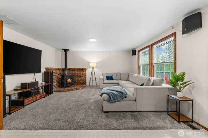 The perfect place to unwind. This inviting living room features a classic wood-burning fireplace, creating a warm and cozy atmosphere for those chilly evenings
