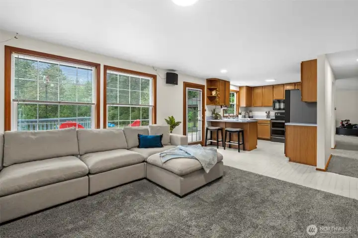 This view highlights the effortless flow between the kitchen and the living room, keeping the home’s main gathering spaces connected and filled with light