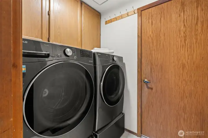 Conveniently located just inside from the garage, this laundry area doubles as a perfect mudroom to drop boots and gear after a day of enjoying the expansive backyard!