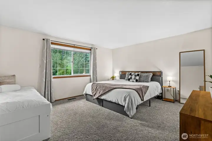 This impressively expansive primary suite offers plenty of room for a king-sized bed and a sitting area, providing a peaceful escape at the end of the day