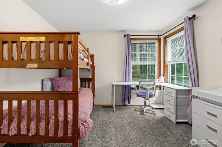 Light, bright, and ready for your touch! This charming third bedroom offers a comfortable layout and large windows, making it an ideal space for a nursery, guest room, or creative studio