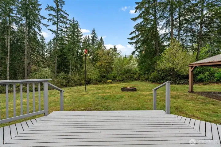 Escape the hustle and bustle. The quiet beauty of the surrounding woods creates a serene atmosphere, making this deck the ideal spot for morning coffee or evening relaxation