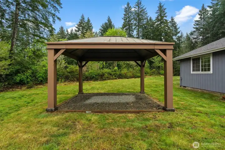 Timeless appeal in the great outdoors. The pergola adds a touch of sophistication to the backyard, offering a picturesque spot to enjoy the surrounding nature and the peace of your private lot