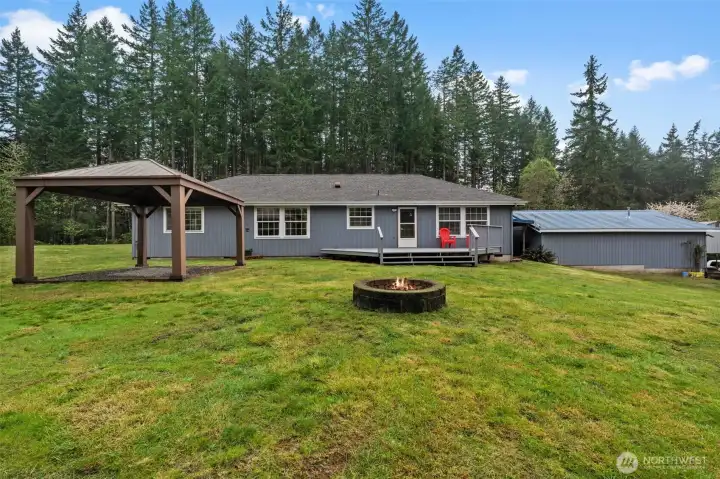 Gather 'round! This dedicated firepit area is the heart of the backyard, offering the perfect place for roasting marshmallows and sharing stories under the stars