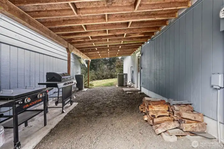 The convenient carport provides a sheltered walkway from the house to the massive detached garage, ensuring you stay dry while moving between your home and your workspace