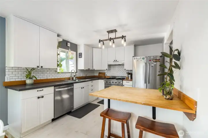 Kitchen with eating space and white shaker cabinets.