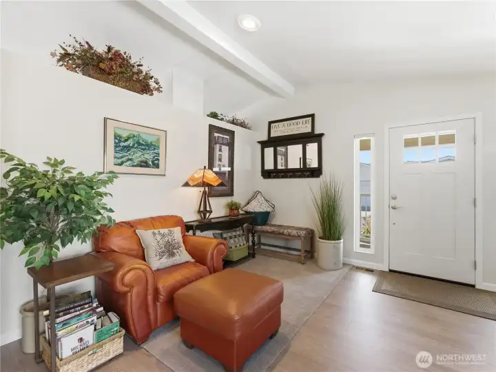 Vaulted living room designed for entertaining and relaxation with seamless flow to adjacent spaces.