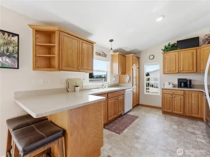 Renovated kitchen featuring updated flooring, stainless steel appliances, and ample cabinet storage.