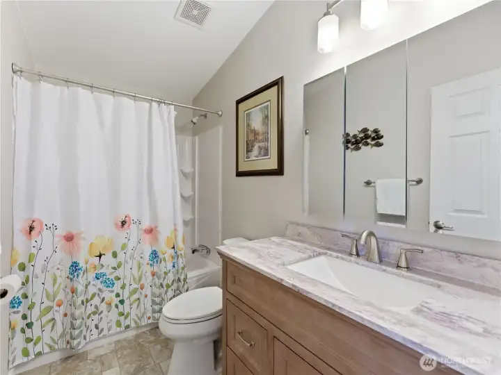 Updated guest bathroom with modern touches and practical design.