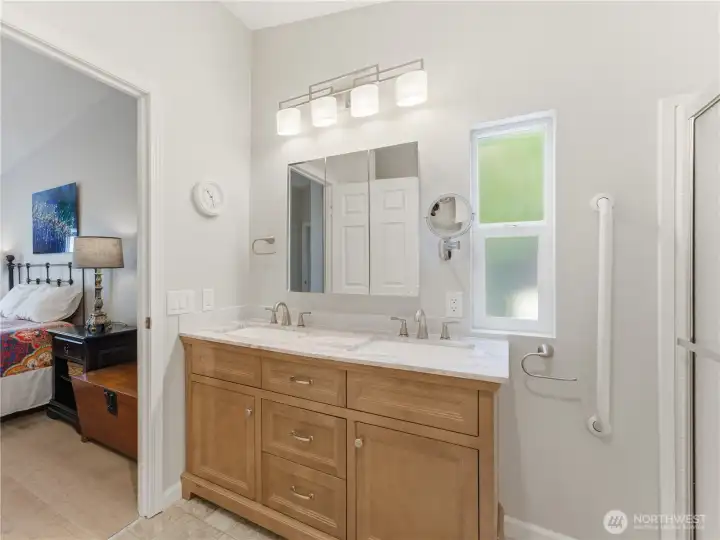Updated primary bathroom featuring a stylish new vanity and modern finishes.