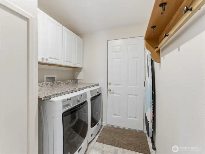 Spacious laundry room offers additional storage and easy access to the garage.