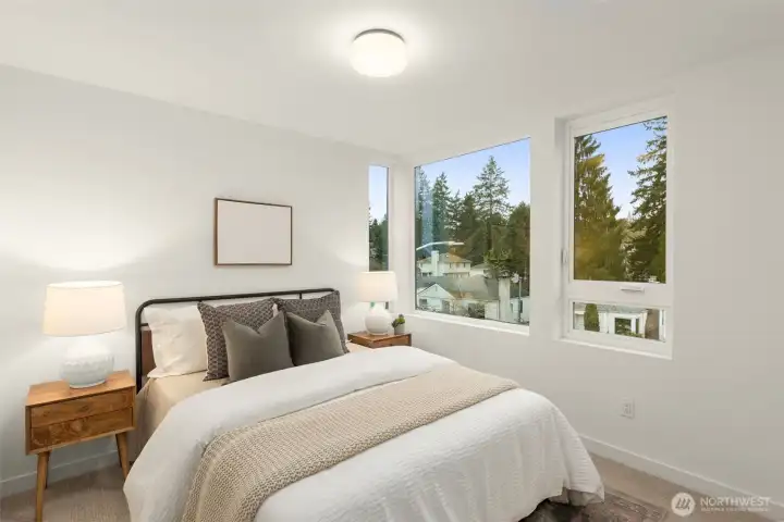 A bright and inviting secondary bedroom features generous dimensions, clean lines, and large windows that fill the space with natural light. A bright and inviting secondary bedroom features generous dimensions, clean lines, and large windows that fill the space with natural light.