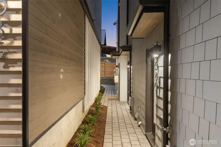 A clean, fenced pathway provides a secure and beautifully landscaped transition along the side of the home. A clean, fenced pathway provides a secure and beautifully landscaped transition along the side of the home.