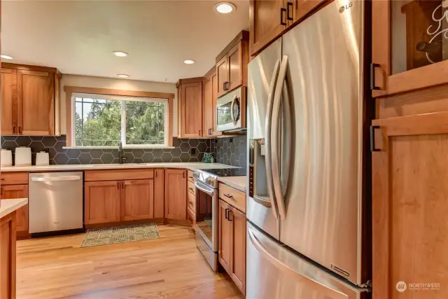 Amazing kitchen with Quartz surfaces, tile backsplash, Cherry cabinets and all stainless appliances.