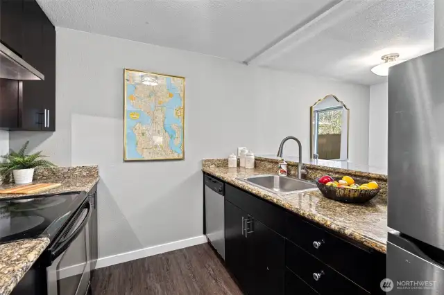 Galley style Kitchen with newer appliances and granite counters
